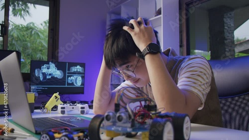 Wallpaper Mural Asian teenager doing Arduino robot homework project in house Torontodigital.ca