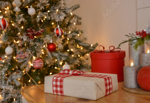 Gift boxes on the background of a Christmas tree, candles. Christmas mood