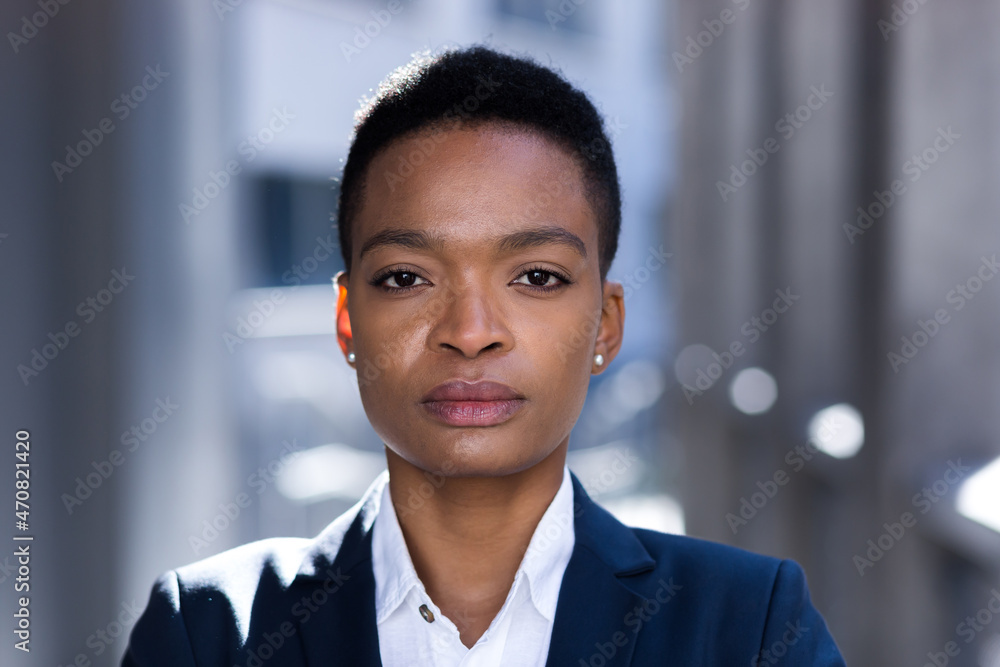 Headshot photo with close up portrait of serious businesswoman, african american woman confident and focused looking at camera Headshot photo with close up portrait of serious businesswoman, african american woman confident and focused looking at camera