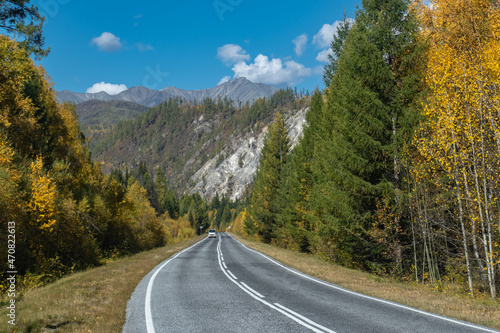 Highway in the autumn forest in the Eastern Sayan Mountains