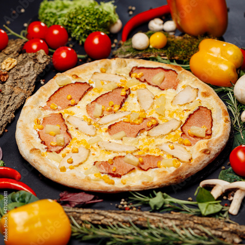 Top view pizza on table top, Flat lay of pizza on black background, Prepared pizza on table for serve Freshly baked homemade pizza isolated on a black background with vegetables. View from above