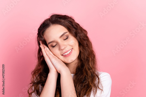 Photo of young charming lady hands touch cheek sleep comfodrt drowse isolated over pink color background