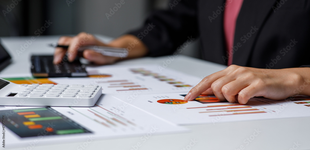 accounting concept. businesswoman working using a laptop with analyzing finance sales data and economic growth graph chart. at the home office. accounting concept. businesswoman working using a laptop with analyzing finance sales data and economic growth graph chart. at the home office.