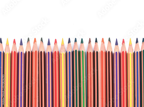 A lot of multicolored pencils isolated on a white background. Close-up on pencils. Stationery