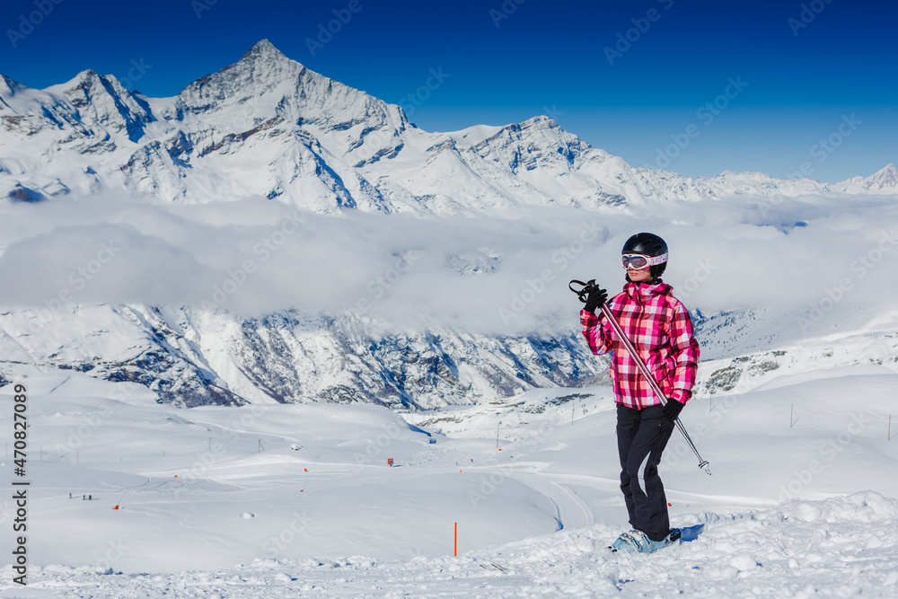 Happy skier girl posing in sunglasses. Winter Alps