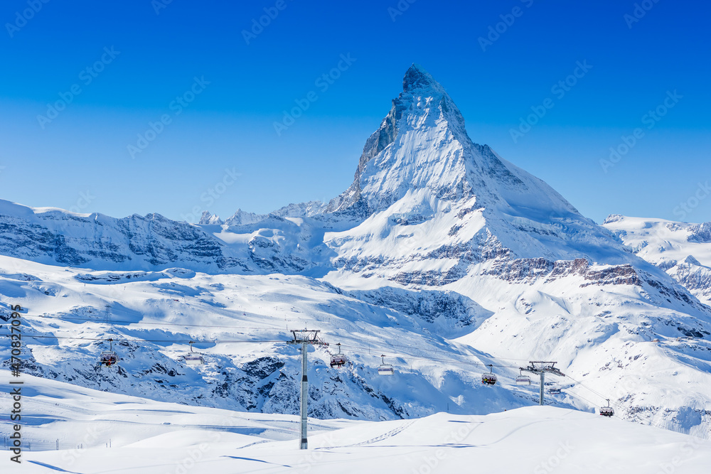 Ski slope and snow covered winter mountains. Matterhorn mountain in winter time