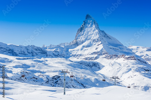 Ski slope and snow covered winter mountains. Matterhorn mountain in winter time © olyphotostories