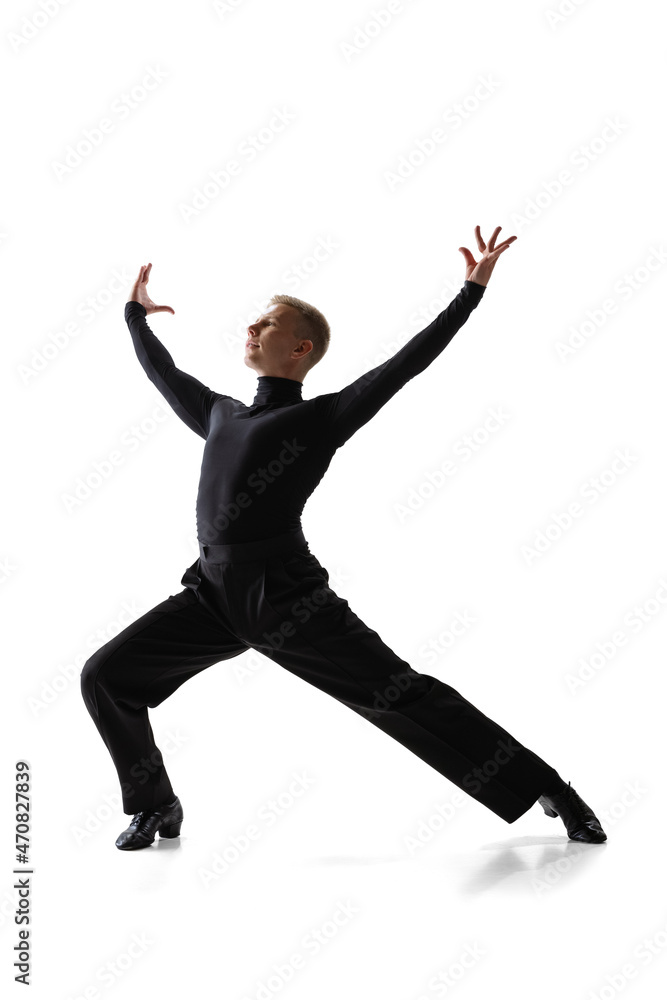 Portrait of young graceful male dancer, flexible man in black stage costume dancing ballroom dance isolated on white studio background. Portrait of young graceful male dancer, flexible man in black stage costume dancing ballroom dance isolated on white studio background.