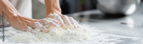 Obraz na plátně Cropped view of chef making dough on restaurant kitchen, banner