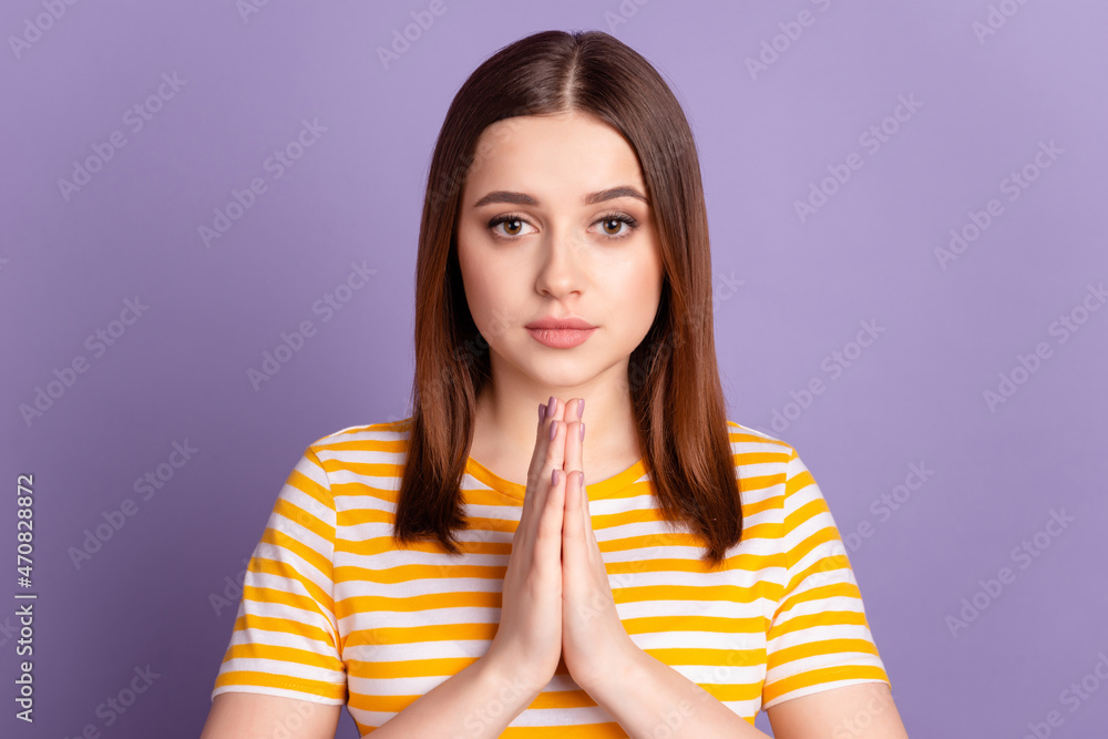 Photo of young attractive girl hands together pray wish luck hope isolated over violet color background Photo of young attractive girl hands together pray wish luck hope isolated over violet color background
