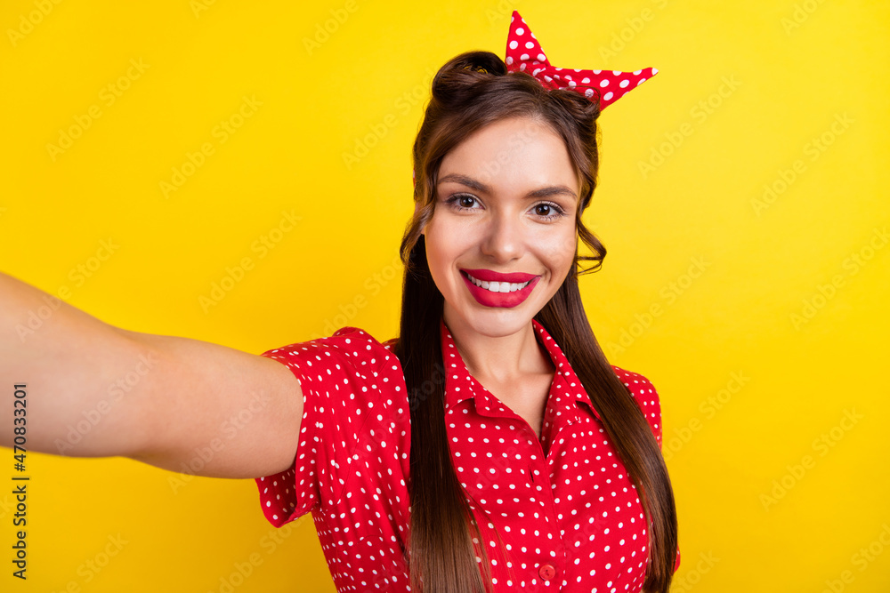 Photo of sweet charming young lady wear dotted outfit tacking selfie smiling isolated yellow color background Photo of sweet charming young lady wear dotted outfit tacking selfie smiling isolated yellow color background