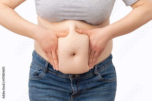Close up tummy of a fat woman with fat belly, chubby, fat belly with overweight woman isolated on white background.