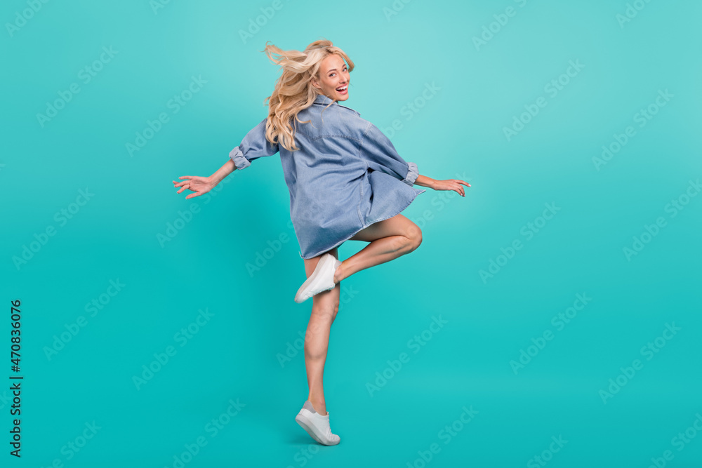 Full length photo of cheerful cool woman win blow air good mood summer isolated on blue color background Full length photo of cheerful cool woman win blow air good mood summer isolated on blue color background