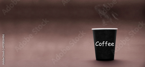 paper cup on brown background. cup on darker texture. coffee drinking concept. the inscription on the image coffee