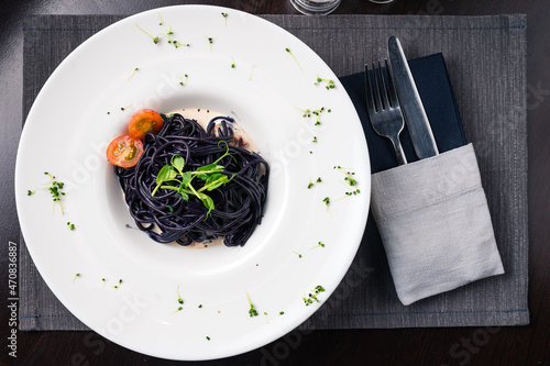 Cuttlefish black spaghetti, black pasta with cherry tomatoes