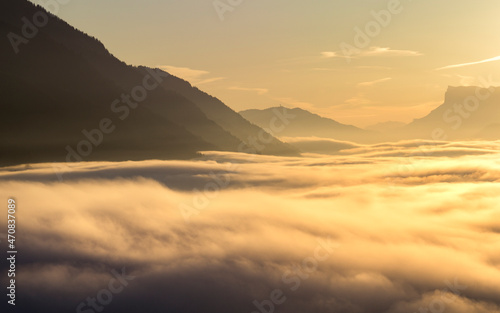 Sea of clouds in the mountains at sunset