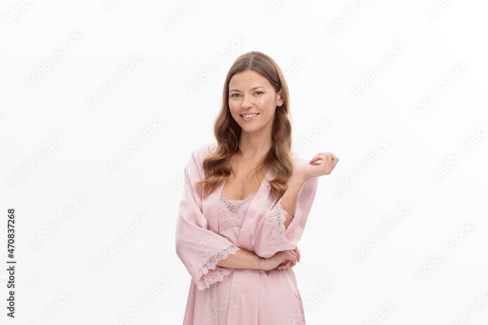 young woman smiling and wearing at pink silk robe, on white background young woman smiling and wearing at pink silk robe, on white background