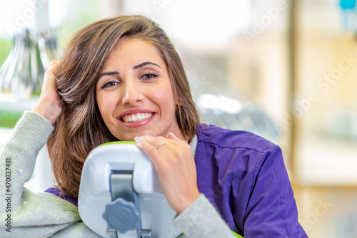 Young smiling woman at the dentist chair