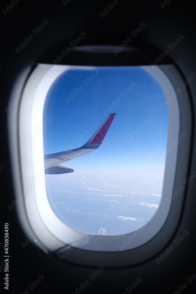 Airplane wing, scenic view from the window. Higher than clouds. Beautiful cloud, blue sky. Traveling by plane, adventure. Flight over Europe. Air transport. Aviation. Holiday in other country. Poster Airplane wing, scenic view from the window. Higher than clouds. Beautiful cloud, blue sky. Traveling by plane, adventure. Flight over Europe. Air transport. Aviation. Holiday in other country. Poster