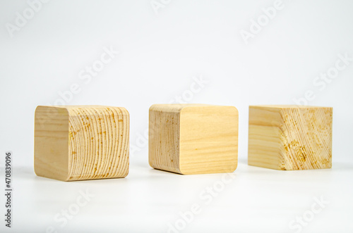 Wooden cubes from different tree species with different edge treatments. several wooden building blocks on a white background. Eco-friendly materials for construction, decoration and repair.