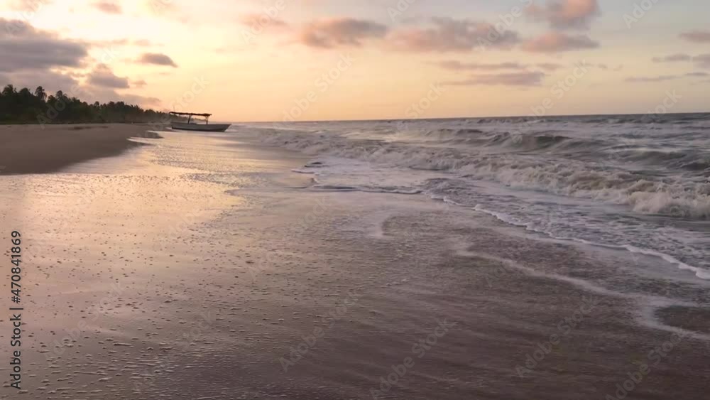 Waves on a sandy Caribbean Sea beach during golden hour Waves on a sandy Caribbean Sea beach during golden hour