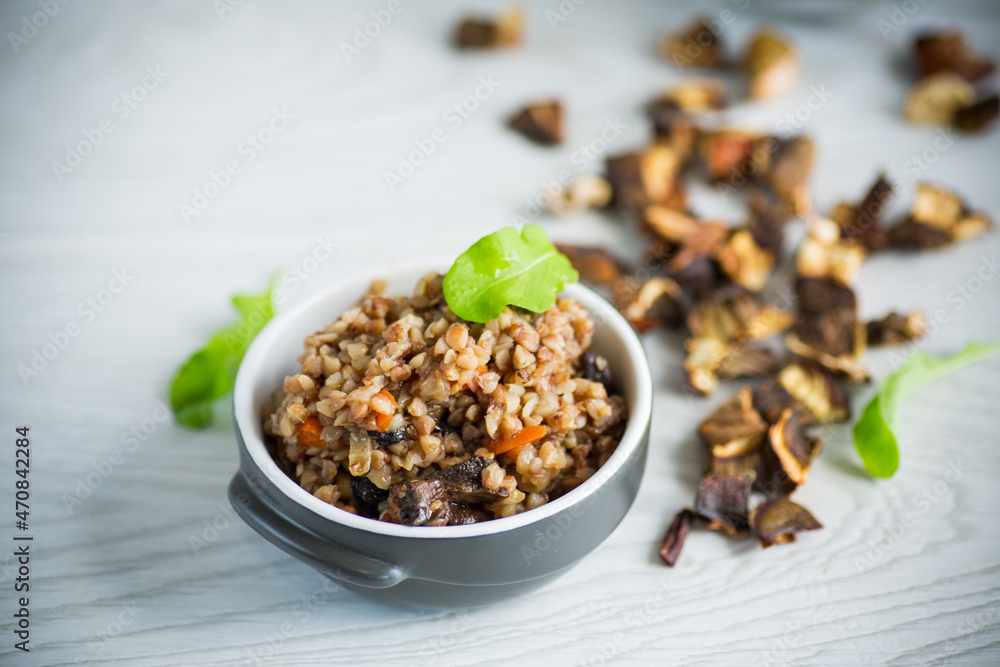 boiled buckwheat with vegetables and dried forest mushrooms in a ceramic mold boiled buckwheat with vegetables and dried forest mushrooms in a ceramic mold