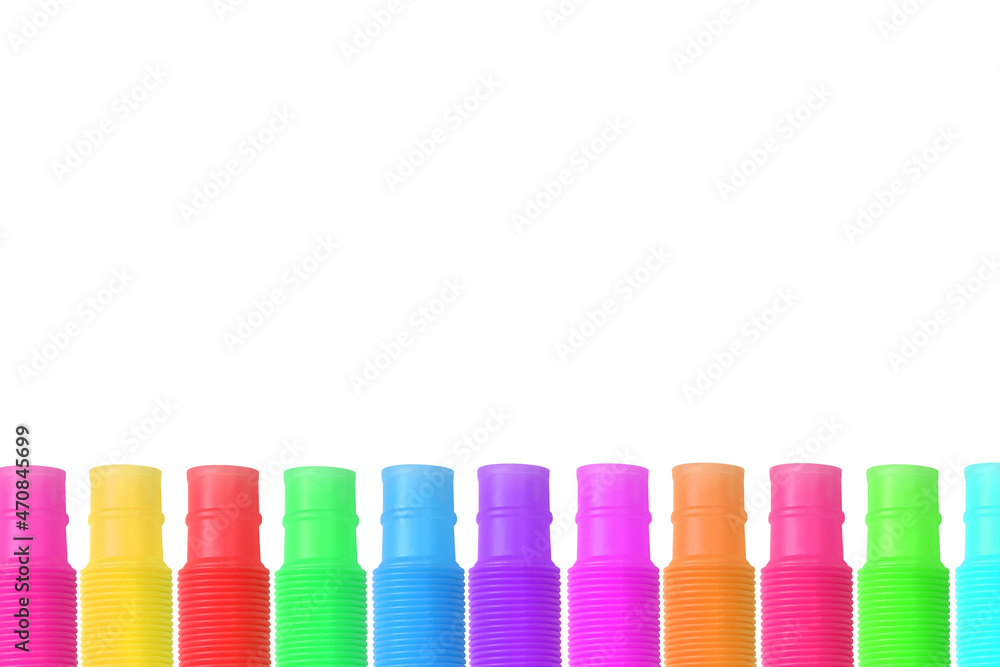 Colorful trendy toys pop tubes on a white background. Design elements. Place for text Colorful trendy toys pop tubes on a white background. Design elements. Place for text