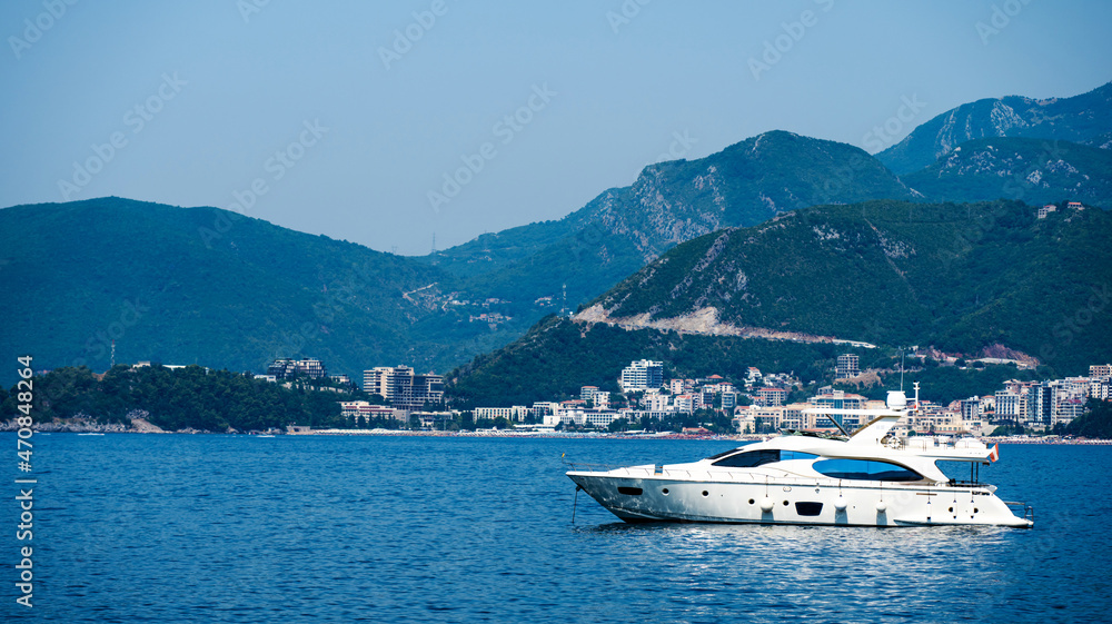 Boat in Adriatic sea with Budva view in Montenegro. Ancient city with mountains from yacht