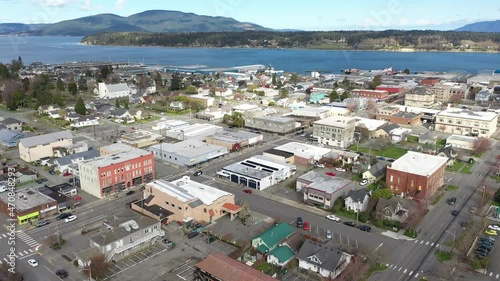 Cinematic 4K aerial drone dolly shot of charming historic Anacortes Midtown, Old Town, waterfront, Guemes Island, Cypress Island in the San Juan Islands, Washington photo