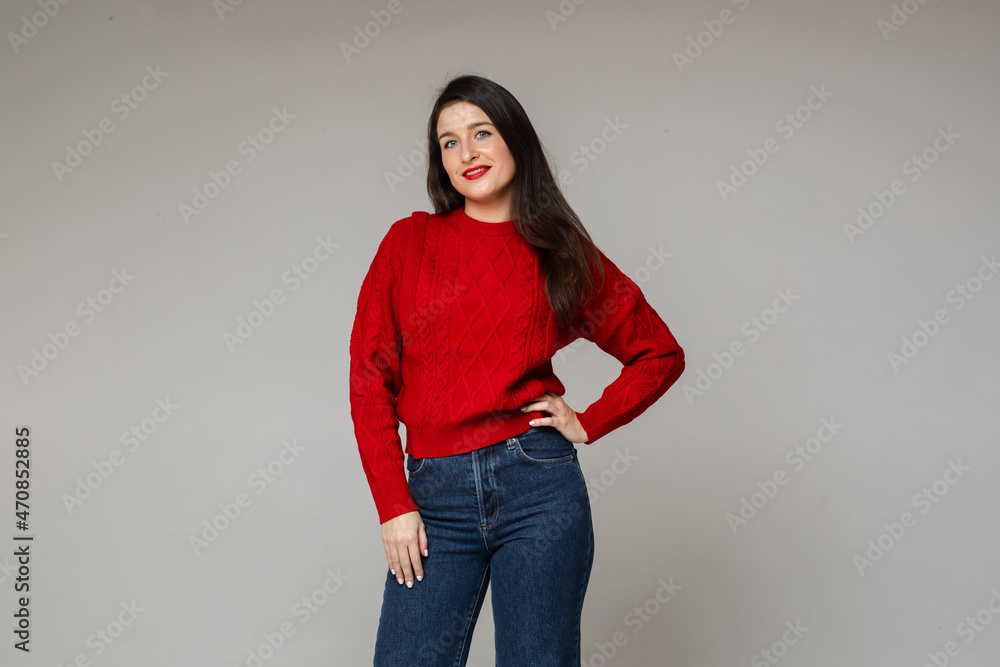 cheerful woman in warm red sweater and blue jeans cheerful woman in warm red sweater and blue jeans