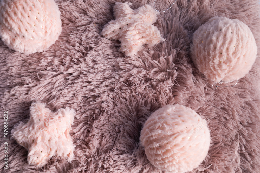 Christmas background with pink fur balls on pink fur background. Winter holidays background. Winter mood Christmas background with pink fur balls on pink fur background. Winter holidays background. Winter mood