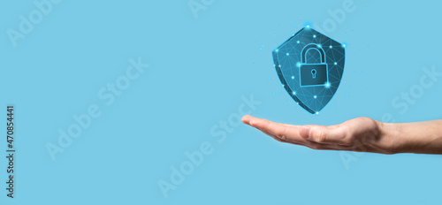 Fototapeta Naklejka Na Ścianę i Meble -  Businessman hold low poly polygon shield with a padlock icon.Secure Access System Concept.Business Financial Warranty for Investment.antivirus concept.Technology security.Protection network,safe data.