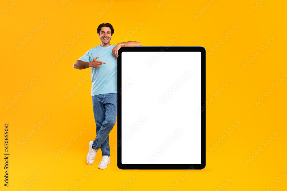 Guy pointing and leaning on big white empty tab screen