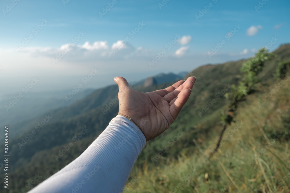 Hands outstretched to receive natural light and mountain views Hands outstretched to receive natural light and mountain views