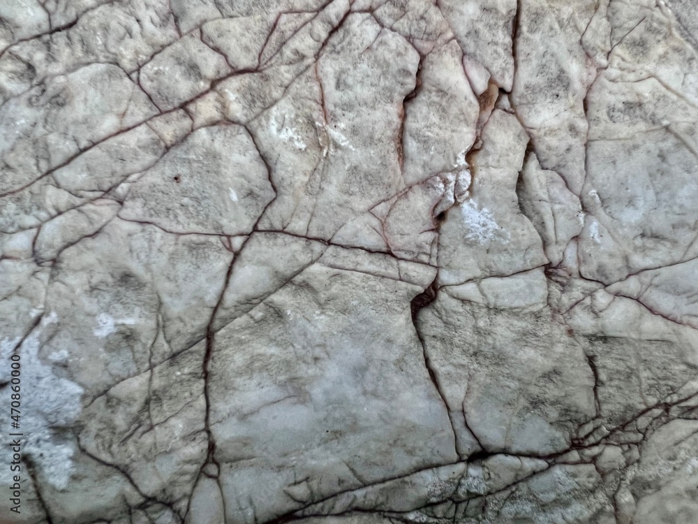Old stone patterns that are broken and have various colors in beautiful patterns, available in black, white, pink, gray and brown, with green moss, black islands on the rock formed a beautiful natural Old stone patterns that are broken and have various colors in beautiful patterns, available in black, white, pink, gray and brown, with green moss, black islands on the rock formed a beautiful natural