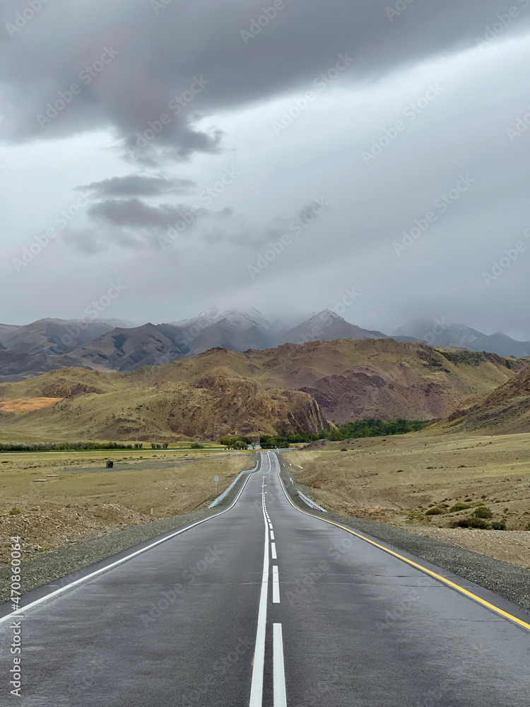 The road goes into the distance in the mountains, a part of the Chuisky tract , Altai, Russia