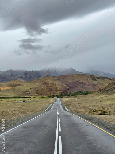 The road goes into the distance in the mountains, a part of the Chuisky tract , Altai, Russia