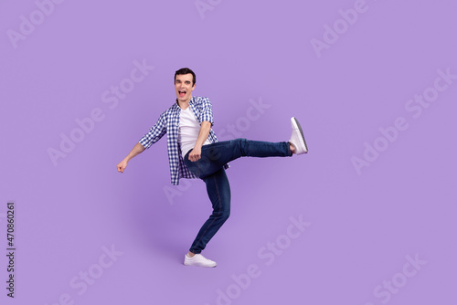 Full length profile side photo of young guy good mood dance party fooling isolated over violet color background