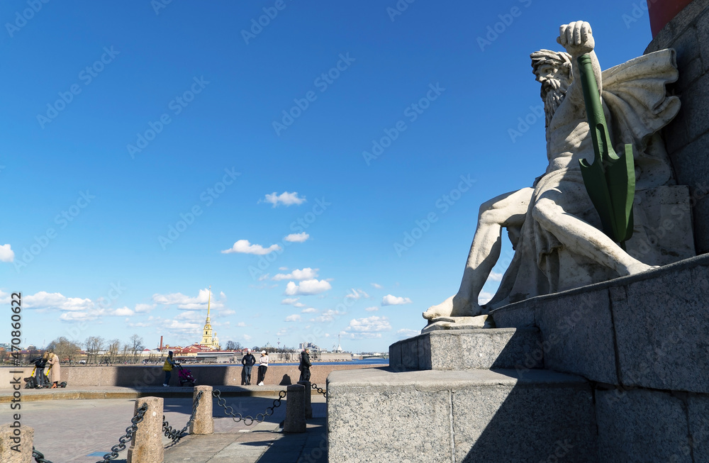 The statue at the foot of the Rostral Column. The arrow of Vasilievsky Island. Saint-Petersburg.