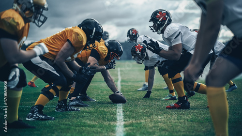 American Football Championship. Teams Ready: Professional Players, Aggressive Face-off, Ready for Pushing, Tackling. Competition Full of Brutal Energy, Power. Shot with Dramatic Light photo