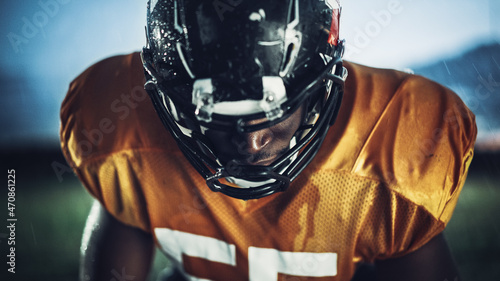 American Football: Close-up of Professional African-American Player Looking at Camera. Hero Athlete Ready to Win the Championship. Determination, Skill, Power. Dramatic Portrait Shot