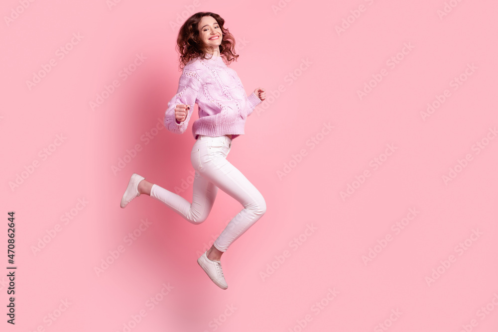 Full size profile side photo of young excited girl have fun jump up isolated over pink color background Full size profile side photo of young excited girl have fun jump up isolated over pink color background