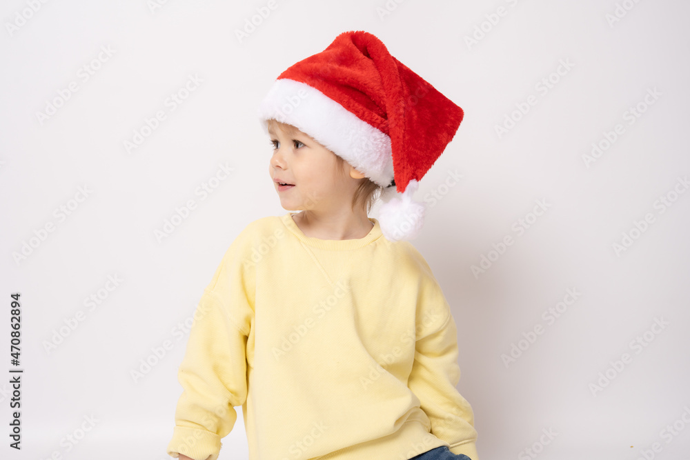 Cute little boy wearing santa hat isolated over white background. Cute little boy wearing santa hat isolated over white background.