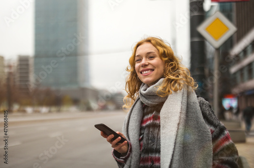 Young woman in the city waiting for a taxi 
