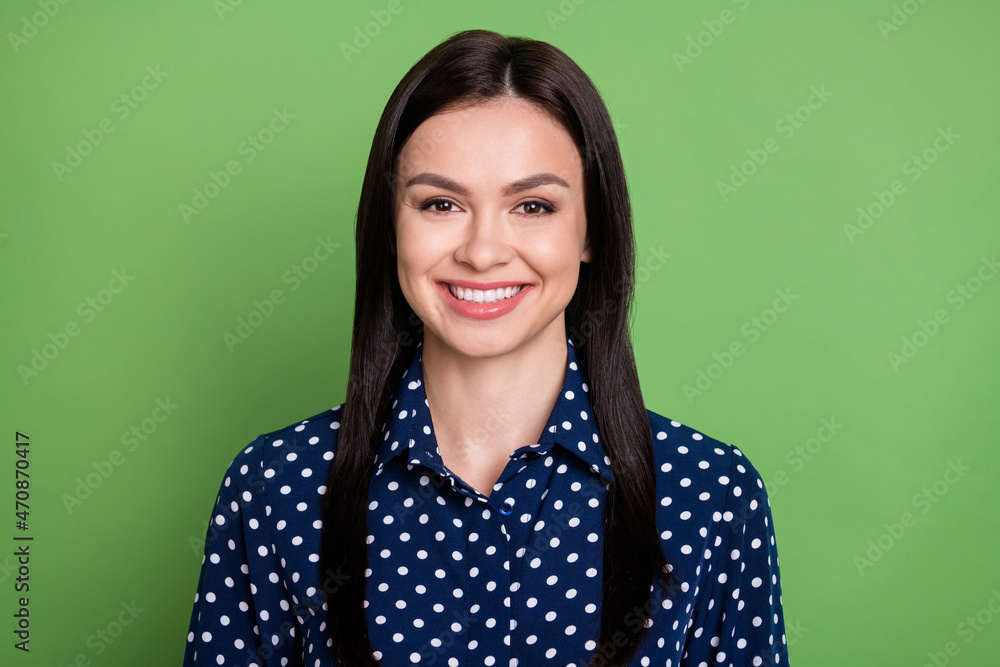 Photo of happy nice young woman good mood face wear blue dotted shirt isolated on green color background Photo of happy nice young woman good mood face wear blue dotted shirt isolated on green color background