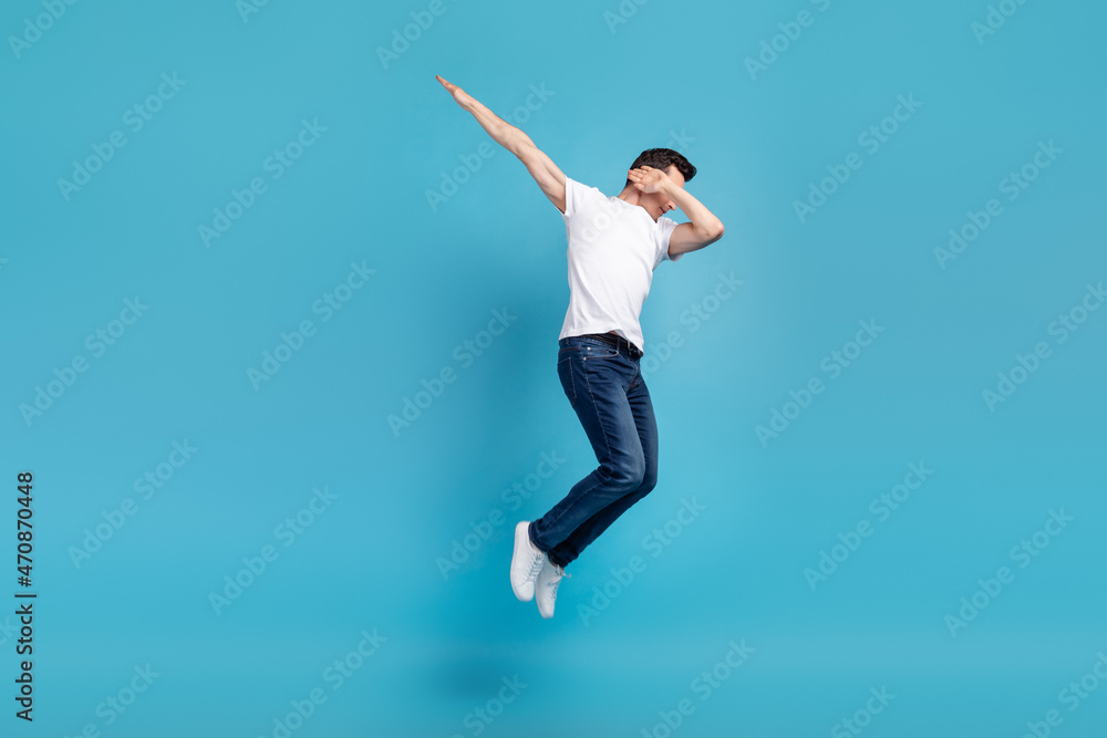 Full body photo of young man jump up close eyes hands dav performance isolated over blue color background