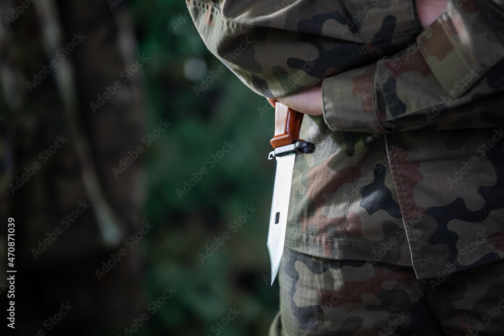 Fotografie, Obraz A soldier stands ready to attack with a sharp bayonet held in his hand