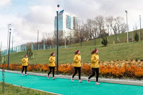 panorama with several images of the same female jogger on a running track against a city background photo