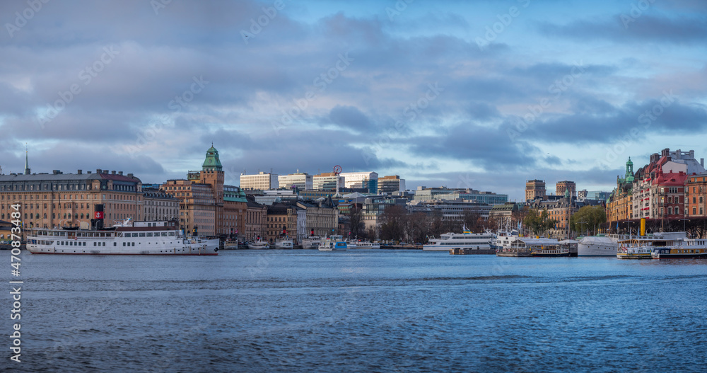 Panorama view over the bay Nybroviken a part of the bay Ladugårdsviken, commuting steam boats and hotels and office buildings at the pier Strandvägen, an color full day in Stockholm
