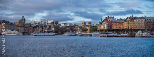 Panorama view over the bay Nybroviken a part of the bay Ladugårdsviken, commuting steam boats and hotels and office buildings at the pier Strandvägen, an color full day in Stockholm 